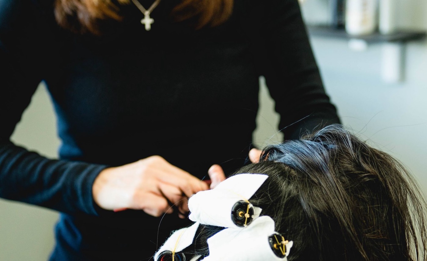 Korean digital perm rods being wound into a client’s hair